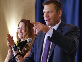 Kansas Republican gubernatorial candidate Kris Kobach and his wife Heather thank their supporters and send them home for the night after problems with polls in Johnson County, Kan., delayed the final results until the early morning on Wednesday, Aug. 8, 2018, at the Capitol Plaza Hotel in Topeka, Kan.