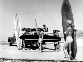 FILE - In this July 12, 1961 file photo members of the North Bay surfing club upload their surf boards from a station wagon at Malibu Beach, Calif, California Gov. Jerry Brown announced Monday, Aug. 20, 2018 that he signed a bill making surfing the official state sport. (AP Photo,File)