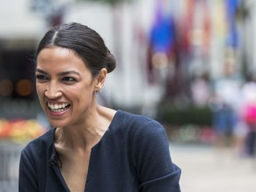 FILE - In this June 27, 2018, file photo, Alexandria Ocasio-Cortez, a winner of a Democratic Congressional primary in New York speaks to a reporter.  Ocasio-Cortez, a rising liberal star who toppled 10-term Democratic Rep. Joe Crowley in a primary, is scheduled to speak at a fundraiser in downtown Los Angeles.
