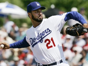 FILE - In this Friday, March 14, 2008, file photo, Los Angeles Dodgers starting pitcher Esteban Loaiza pitches to St. Louis Cardinals' Cesar Izturis during the first inning of a spring training baseball game in Vero Beach, Fla. Former All-Star pitcher Loaiza has pleaded guilty to possession of about 20 kilograms of cocaine with intent to distribute. The 46-year-old acknowledged in a San Diego courtroom Friday, Aug. 10, 2018, that he possessed about 20 kilograms (44 pounds) of cocaine with intent to distribute. He faces up to life in prison when he is sentenced Nov. 2. Loaiza had been under surveillance when he was arrested in February near a house in Imperial Beach, which borders Tijuana, Mexico. His sliver Mercedes SUV had just left the garage when authorities stopped him.