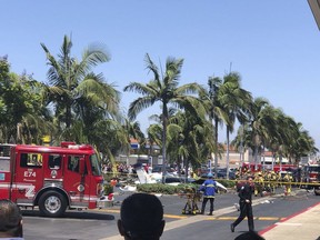 This photo provided by Eddie Ponsdomenech shows a twin-engine aircraft crashed near the South Coast Plaza shopping center in Santa Ana, Calif., Sunday, Aug. 5, 2018. Federal Aviation Administration spokeswoman Arlene Salac says the twin-engine Cessna 414 declared an emergency before crashing about a mile (1.6 kilometers) from Orange County's John Wayne Airport.