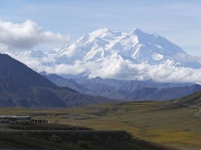 FILE - In this Aug. 26, 2016, file photo sightseeing buses and tourists are seen at a pullout popular for taking in views of North America's tallest peak, Denali, in Denali National Park and Preserve, Alaska. Rescuers are attempting to locate a sightseeing plane that crashed with the pilot and four passengers aboard high on a mountain ridge in Denali National Park and Preserve. The pilot reported on his satellite phone Saturday, Aug. 4, 2018, that there were some injuries but authorities couldn't get details before the satellite connection dropped.
