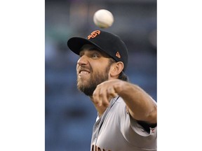 San Francisco Giants starting pitcher Madison Bumgarner throws to the plate during the first inning of a baseball game against the Los Angeles Dodgers Monday, Aug. 13, 2018, in Los Angeles.