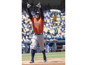 Houston Astros' George Springer celebrates his solo home run during the first inning of a baseball game against the Los Angeles Dodgers in Los Angeles, Sunday, Aug. 5, 2018.