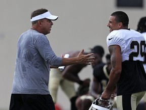 New Orleans Saints head coach Sean Payton, left, talks with safety Kurt Coleman (29) during training camp at their NFL football training facility in Metairie, La., Monday, July 30, 2018.