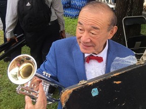 Trumpet player and singer Yoshio Toyama talks with an admirer in New Orleans on Saturday, Aug. 4, 2018. Known as the "Japanese Sachmo" for his devotion to jazz great Louis Armstrong, Toyama and his wife Keiko Toyama performed with their band the Dixie Saints at Satchmo Summerfest, held annually to mark Armstrong's birthday.