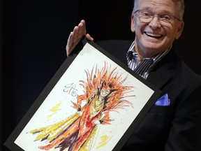 Fashion and Costume Designer Bob Mackie poses with one of his illustrations, a marker and pencil costume sketch of Elton John as a devil for his 1986 Ice on Fire tour, in London, Thursday, Aug. 16, 2018. The sketch which is signed by Bob is estimated at 1,000-2,000 US Dollars (788-1,575 UK Pounds) and will be auctioned in the 'Property from the Collection of Bob Mackie' sale by Julien's Auctions in Los Angeles on Nov. 17.