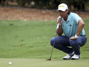 FILE - In this Friday, Oct. 13, 2017 file photo, Gavin Green of Malaysia lines up his putt during the second day of the CIMB Classic golf tournament at Tournament Players Club in Kuala Lumpur, Malaysia. Gavin Green boosted his chances of becoming the first Malaysian to win on the European Tour after claiming a one-shot lead following the second round of the Czech Masters on Friday, Aug. 24, 2018 while John Daly followed his opening 64 with a poor 3-over 75.