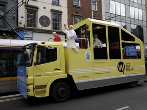 A recently unveiled waxwork of Pope Francis, center, stands with waxworks of Pope John Paul, left, and Pope Benedict XVI, right, on a refurbished 1979 Popemobile in Dublin, Ireland, Friday, Aug. 24, 2018. Pope Francis arrives on Saturday for a two-day visit to Ireland.
