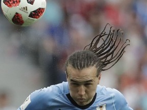 FILE - In this file photo dated Friday, July 6, 2018, Uruguay's Diego Laxalt during the quarterfinal match between Uruguay and France at the 2018 soccer World Cup in the Nizhny Novgorod Stadium, in Nizhny Novgorod, Russia.  AC Milan has signed midfielder Diego Laxalt on deadline day for the summer transfer window, following his standout performances for Uruguay at the recent soccer World Cup.