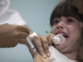 FILE - In this file photo dated Monday, Aug. 6, 2018, a child receives a measles vaccination in Rio de Janeiro, Brazil.  The World Health Organization (WTO) said Monday Aug. 20, 2018, the number of measles cases in Europe jumped sharply during the first six months of 2018 with at least 37 people dead from the disease, and called for increased immunization rates to prevent an endemic.