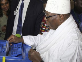 FILE - In this file photo dated Sunday, July 29, 2018, Mali Incumbent President, Ibrahim Boubacar Keita, casts his ballot in Bamako, Mali, during the first round of presidential elections.  In a run-off round two election on Sunday Aug. 12, 2018, Ibrahim Boubacar Keita faces off against Soumaila Cisse.