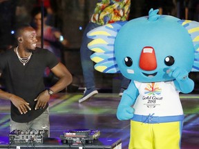FILE - In this file photo dated Sunday, April 15, 2018, Usain Bolt, retired Jamaican world record sprinter, performs as a DJ at Carrara Stadium during the closing ceremony of the 2018 Commonwealth Games on the Gold Coast, Australia.  Bolt has negotiated an "indefinite training period" with Central Coast Mariners in Australia's A-League as he pursues his bid to become a professional soccer player, according to a statement released Tuesday Aug. 7, 2018.