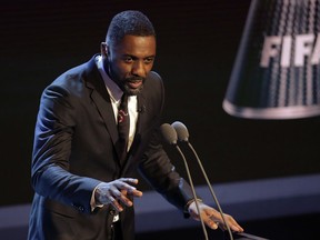 FILE - In this file photo dated Monday, Oct. 23, 2017,  Actor Idris Elba speaks during The Best FIFA 2017 Awards in London. British actor Idris Elba has stoked speculation he may take over the role of James Bond when Daniel Craig steps aside, offering an enigmatic Twitter post Sunday Aug. 12, 2018, saying "my name's Elba, Idris Elba,'' fuelling the buzz about him becoming the first black Bond.