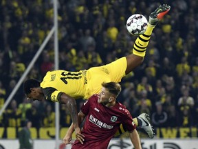 Borussia Dortmund's Manuel Akanji, top, flies over Hannover 96's Niclas Fullkrug as they fight for the ball during a German soccer match Friday, Aug. 31, 2018, in Hannover, Germany.