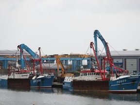The Honeybourne 3, right, a Scottish scallop dredger, in dock at Shoreham, south England, Wednesday Aug. 29, 2018, following clashes with French fishermen in the early hours of Tuesday morning off France's northern coast. French maritime authorities are appealing for calm after fishermen from rival French and British fleets banged their boats in ill-tempered skirmishes over access to the scallop-rich waters off France's northern coast.