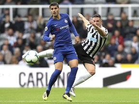 Chelsea's Alvaro Morata, left, and Newcastle United's Ciaran Clark in action during their English Premier League soccer match at St James' Park in Newcastle, England, Sunday Aug. 26, 2018.