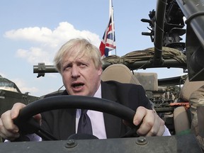 Boris Johnson takes part in a ceremony at the Tomb of the Unknown Soldier in Warsaw, Poland, on June 21, 2018, while still British Foreign Secretary. Johnson is in hot water for saying in a newspaper column that women wearing burkas look like "letterboxes."