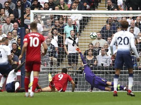 Fulham's Aleksandar Mitrovic, centre, scores his side's first goal of the game during their English Premier League soccer match at Wembley Stadium in London, Saturday Aug. 18, 2018.