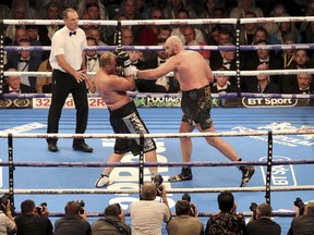 Tyson Fury, right, in action against Francesco Pianeta during their Heavyweight fight at Windsor Park in Belfast, Northern Ireland, Saturday Aug. 18, 2018. fury went on to win the bout.