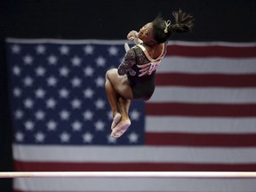 Simone Biles competes on the uneven bars at the U.S. Gymnastics Championships, Friday, Aug. 17, 2018, in Boston.