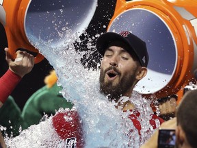 Boston Red Sox starting pitcher Rick Porcello is doused after he pitched a one-hitter against the New York Yankees in a baseball game at Fenway Park, Friday, Aug. 3, 2018, in Boston. The Red Sox won 4-1.
