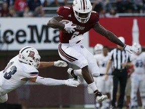 Massachusetts running back Marquis Young (8) evades Duquesne defensive back Peter Ausiello (43) during the first half of an NCAA college football game in Amherst, Mass., Saturday, Aug. 25, 2018.