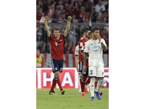 Bayern's Thomas Mueller, left, celebrates after scoring his side's opening goal during the German Bundesliga soccer match between FC Bayern Munich and TSG 1899 Hoffenheim in Munich, Germany, Friday, Aug. 24, 2018.