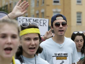 David Hogg, center right, a survivor of the school shooting at Marjory Stoneman Douglas High School, in Parkland, Fla., walks in a planned 50-mile march, Thursday, Aug. 23, 2018, in Worcester, Mass. The march, held to call for gun law reforms, began Thursday, in Worcester, and is scheduled to end Sunday, Aug. 26, 2018, in Springfield, Mass., at the headquarters of gun manufacturer Smith & Wesson.