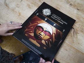 A person looks at a volume from the Indigenous Peoples Atlas of Canada at a launch event in Toronto, Wednesday August 29, 2018.