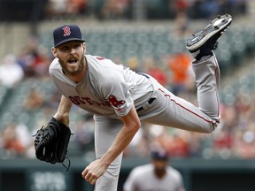 Boston Red Sox starting pitcher Chris Sale follows through on a pitch to the Baltimore Orioles in the first inning of a baseball game, Sunday, Aug. 12, 2018, in Baltimore.