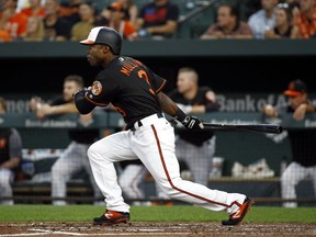 Baltimore Orioles' Cedric Mullins doubles in the second inning of a baseball game against the Boston Red Sox, Friday, Aug. 10, 2018, in Baltimore. Renato Nunez scored on the play.