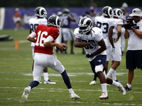 Los Angeles Rams running back Todd Gurley, right, runs a drill with quarterback Jared Goff during a joint NFL football training camp practice at the Baltimore Raven's headquarters, Tuesday, Aug. 7, 2018, in Owings Mills, Md.