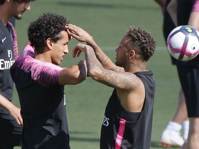 PSG's Marquinhos, left, and Neymar joke together during a training session at the Camp des Loges training center in Saint Germain en Laye, west of Paris, France, Saturday, Aug. 11, 2018. Paris Saint Germain will face Caen during their first match of the French League One session at Parc des Princes stadium on Sunday Aug. 12, 2018.