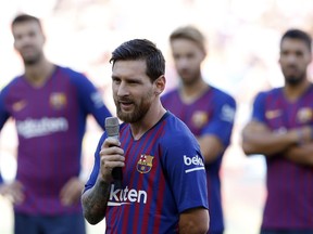 FC Barcelona's Lionel Messi talks to the crowd ahead of the Joan Gamper trophy friendly soccer match between FC Barcelona and Boca Juniors at the Camp Nou stadium in Barcelona, Spain, Wednesday, Aug. 15, 2018.