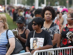 Fans wait in line at the Charles H. Wright Museum of African American History where Aretha Franklin is lying in state, Tuesday, Aug. 28, 2018, in Detroit.