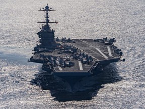 In this Friday, Dec. 25, 2015 photo released by the U.S. Navy, the aircraft carrier USS Harry S. Truman navigates the Gulf of Oman.