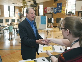 Grosse Pointe financier Sandy Pensler, who is running for the GOP U.S. Senate nomination, thanks election worker Courtney Delmege after casting his ballot in the Michigan primary election at Trombly School in Grosse Pointe Park on Tuesday, Aug. 7, 2018.