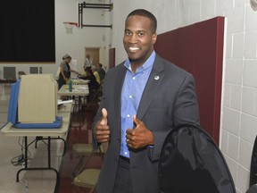 Michigan U.S. Senate candidate John James gives a thumbs up after casting his ballot on Tuesday, Aug. 7, 2018 at Orchard United Methodist Church in Farmington Hills, Mich.