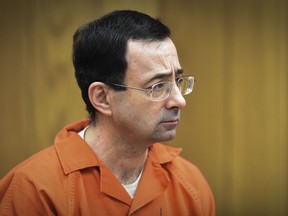 FILE - In this Feb. 5, 2018 file photo, Larry Nassar, former sports doctor who admitted molesting some of the nation's top gymnasts, appears in Eaton County Court in Charlotte, Mich. Numerous people have been criminally charged, fired or forced out of jobs in the wake of the scandal involving once-renowned gymnastics doctor, Nassar, who is serving decades in prison for molesting athletes and for child pornography crimes.