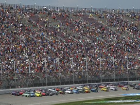 Pole sitter Denny Hamlin leads the field to the start line during a NASCAR Cup Series auto race at Michigan International Speedway in Brooklyn, Mich., Sunday, Aug. 12, 2018.