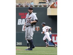 Detroit Tigers pitcher Alex Wilson, left, gives up a solo home run to break the tie by Minnesota Twins' Eddie Rosario, right, in the eighth inning of a baseball game Sunday, Aug. 19, 2018, in Minneapolis. The Twins won 5-4. Wilson picked the loss.