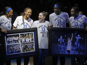 CORRECTS DATELINE TO MINNEAPOLIS INSTEAD OF ST. PAUL, MINN. - Lindsay Whalen, center, smiles with her teammates during a ceremony honoring her last regular season game for the Minnesota Lynx Sunday, Aug. 19, 2018, in Minneapolis. Whalen scored 10 points in the final regular-season home game of her career. The Lynx closed the WNBA basketball season with a 88-83 victory over the Washington Mystics.