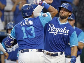 Kansas City Royals' Salvador Perez (13) celebrates with Alex Gordon after hitting a three-run home run during the first inning of a baseball game against the Cleveland Indians on Friday, Aug. 24, 2018, in Kansas City, Mo.