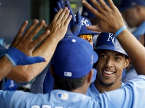 Kansas City Royals' Adalberto Mondesi celebrates with Salvador Perez in the dugout after hitting a two-run home run during the second inning of a baseball game against the Detroit Tigers Wednesday, Aug. 29, 2018, in Kansas City, Mo.