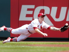 St. Louis Cardinals right fielder Tyler O'Neill makes a diving catch for an out on a fly ball hit by Colorado Rockies' Trevor Story during the fourth inning of a baseball game Thursday, Aug. 2, 2018, in St. Louis.