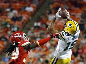 Green Bay Packers wide receiver Equanimeous St. Brown (19) makes a catch over Kansas City Chiefs cornerback Tremon Smith (39) during the first half of an NFL preseason football game in Kansas City, Mo., Thursday, Aug. 30, 2018.