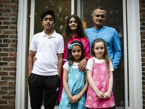 Parents Kamran and Reshma Niazi with their adopted children, from left, Aaliya (7) and Lilly (8) pose for a photograph in their home in Oakville, Ont., on Monday, August 6, 2018.