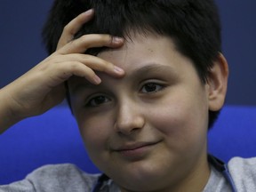12-year-old Carlos Santamaria Diaz smiles during a press conference at Mexico's National Autonomous University in Mexico City, Friday, Aug. 3, 2018. The university, better known by its Spanish initials as the UNAM, said Thursday that Carlos Santamaria Diaz is the youngest such student in the university's roughly century-long history.