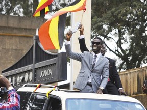 In this photo taken Tuesday, July 11, 2017, Ugandan pop star Kyagulanyi Ssentamu, better known as Bobi Wine, center, gestures to supporters shortly after being sworn in as a member of parliament in Kampala, Uganda. The 36-year-old "ghetto child" is a new member of parliament who urges his countrymen to stand up against what he calls a failing government but was charged Thursday, Aug. 16, 2018 in a military court over his alleged role in clashes in the northwestern town of Arua where both he and President Yoweri Museveni were campaigning.